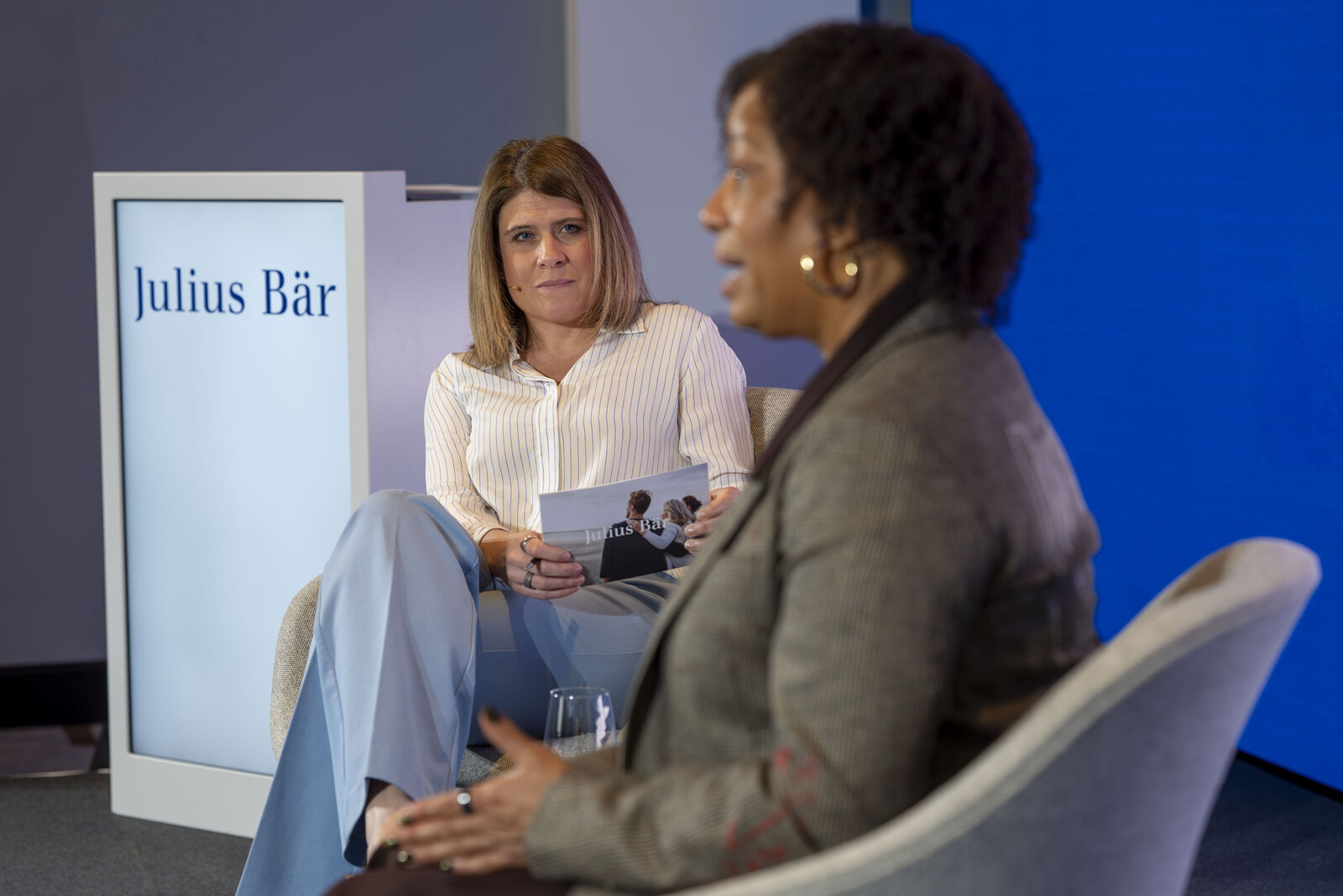 Two speakers in conversation on stage at a live event