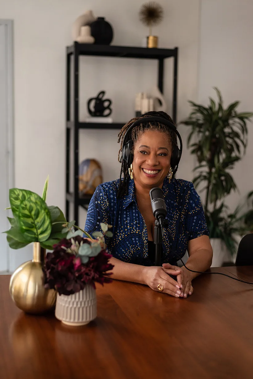 Lisane Basquiat in headphones at a podcast microphone