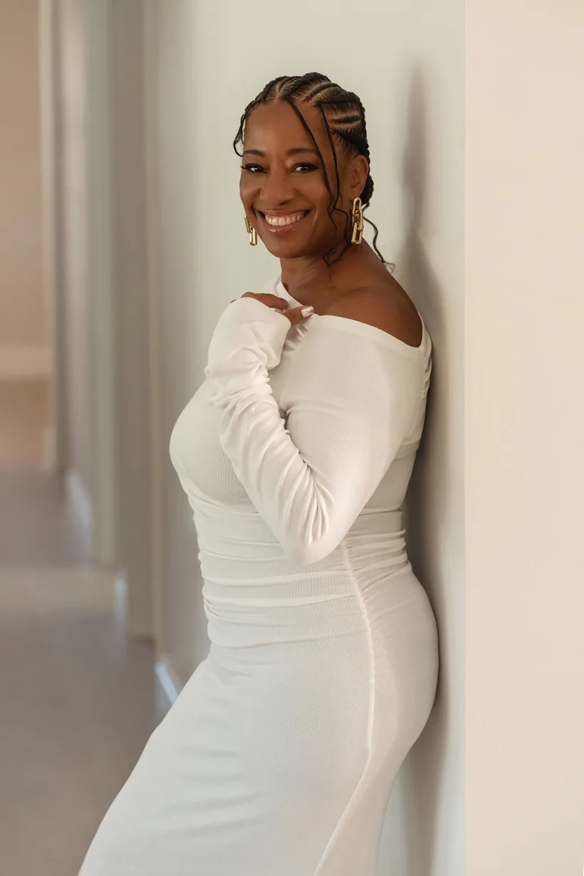 Lisane Basquiat standing in a white dress