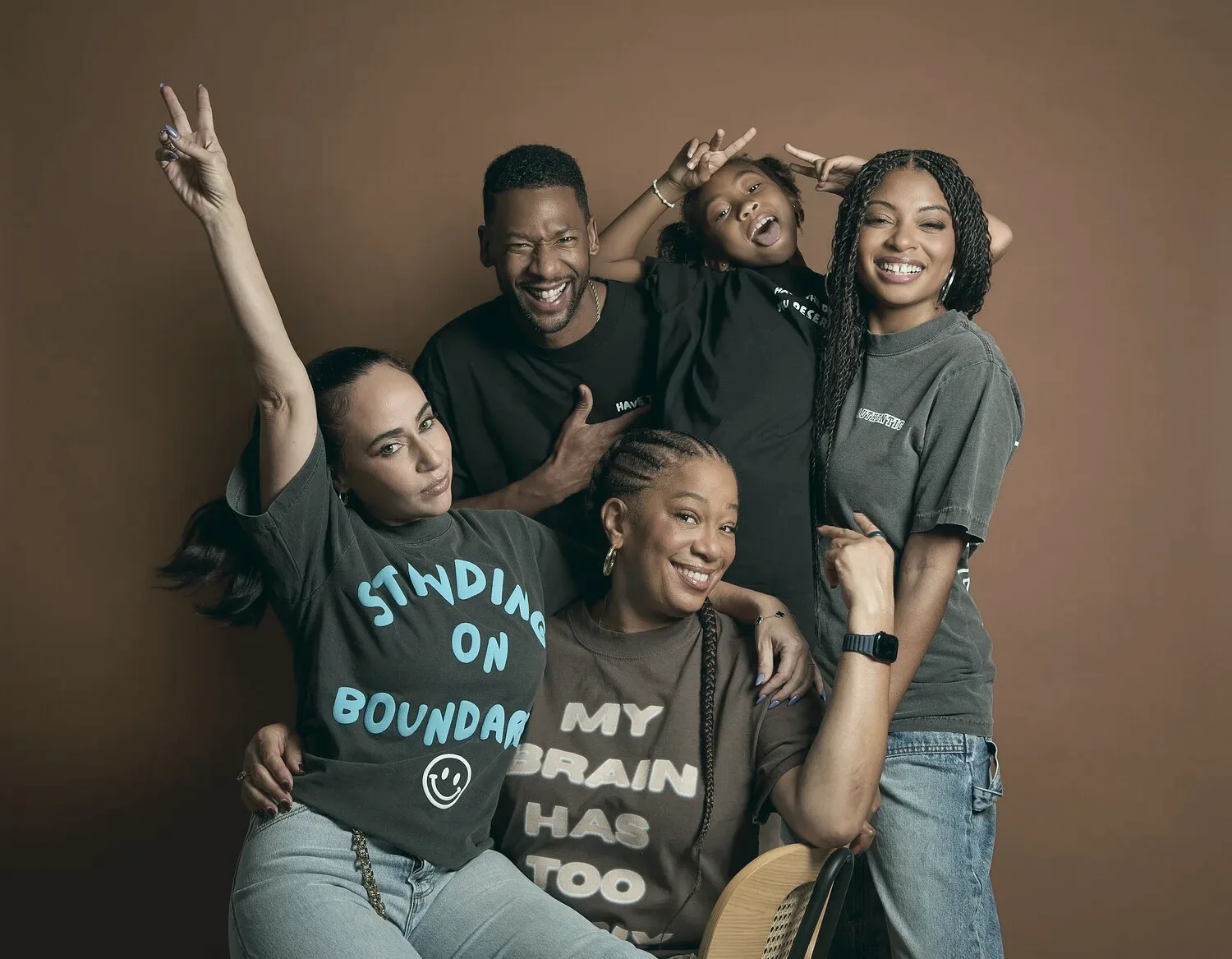 A family in Wear the Work apparel, laughing together.